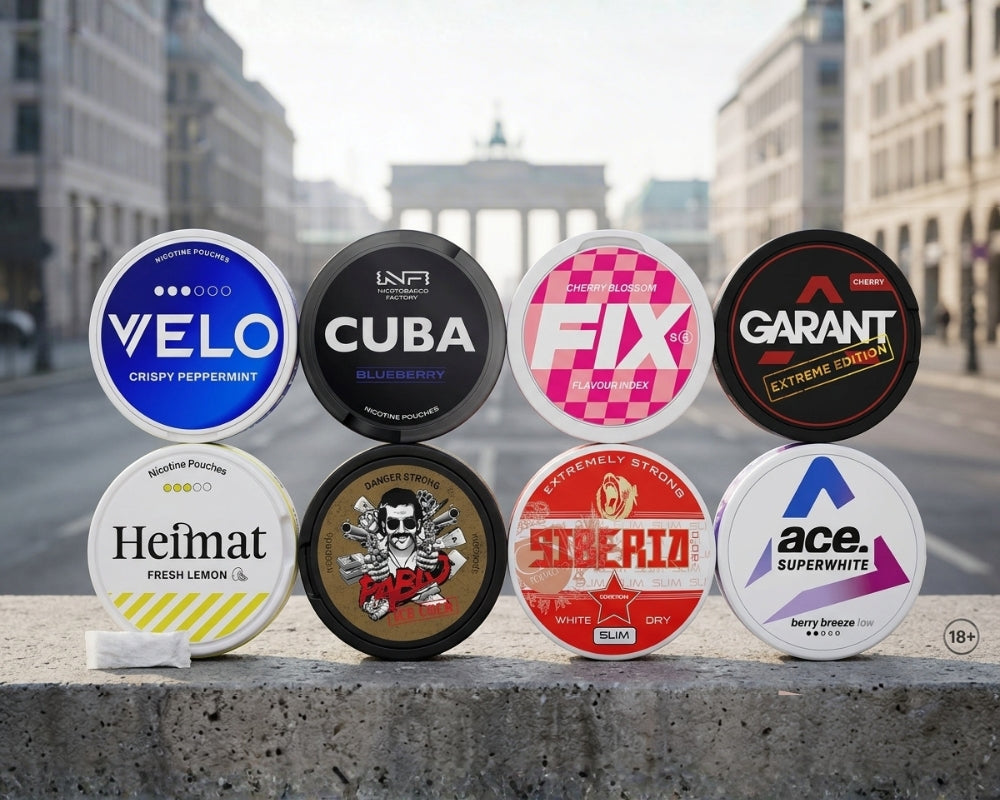 Eight nicotine pouch cans lined up on a ledge in front of the Brandenburg Gate in Berlin