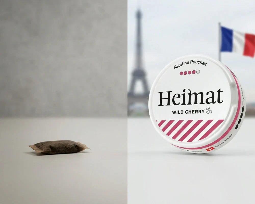 A brown traditional snus portion beside a Heimat Wild Cherry nicotine pouch can, with the Eiffel Tower and a French flag behind